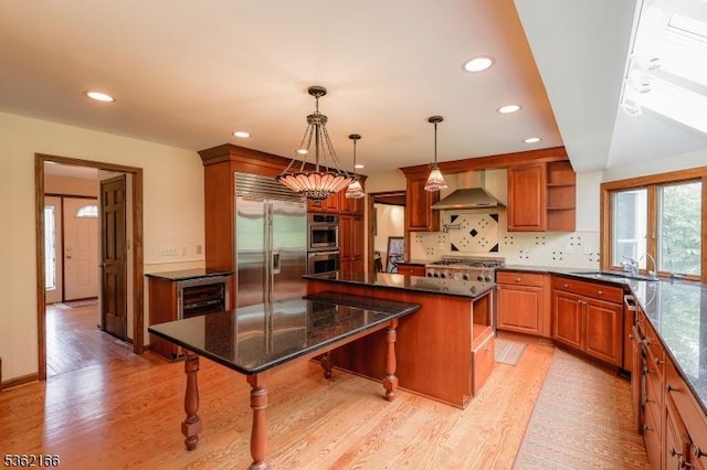 1 Willow Brook Ln, Clinton Twp, NJ 08801 - kitchen featuring open shelves, wall chimney range hood, appliances with stainless steel finishes, light wood finished floors, and a kitchen island