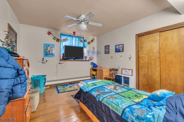 192 Market St, Belvidere Twp, NJ 07823 - bedroom featuring light wood-style floors, baseboard heating, ceiling fan, and a closet