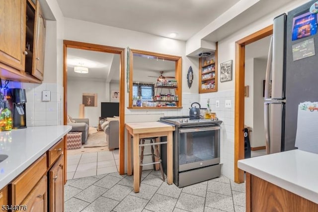192 Market St, Belvidere Twp, NJ 07823 - kitchen featuring stainless steel appliances, brown cabinetry, light countertops, and backsplash