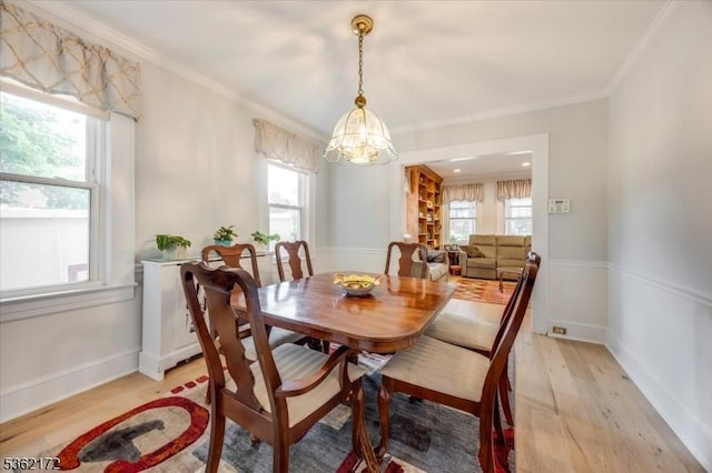 136 Pershing Ave, Nutley Twp, NJ 07110 - dining area with a chandelier, light wood-style floors, plenty of natural light, crown molding, and baseboards