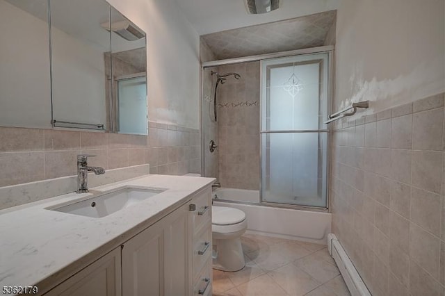 457 Central Ave, New Providence Boro, NJ 07974 - full bath featuring tile walls, vanity, toilet, bath / shower combo with glass door, and tile patterned floors