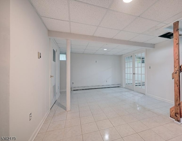 457 Central Ave, New Providence Boro, NJ 07974 - spare room featuring a baseboard heating unit, a paneled ceiling, baseboards, light tile patterned floors, and french doors
