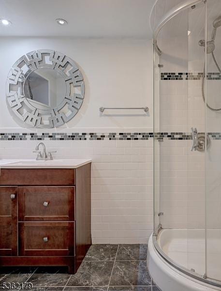 457 Central Ave, New Providence Boro, NJ 07974 - bathroom with a stall shower, vanity, recessed lighting, and tile walls