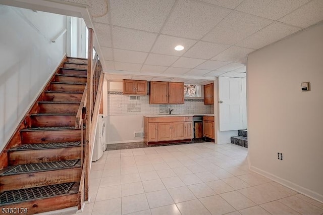 457 Central Ave, New Providence Boro, NJ 07974 - kitchen featuring light countertops, baseboards, a paneled ceiling, decorative backsplash, and a sink