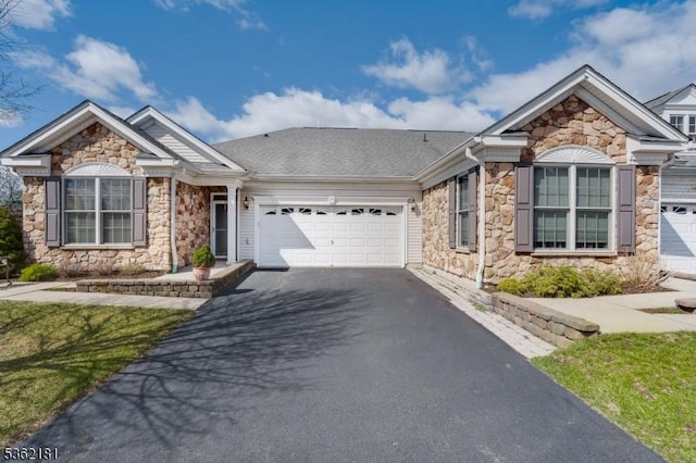 24 Quartz Way, Woodland Park, NJ 07424 - view of front of home featuring stone siding, driveway, and an attached garage