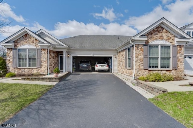 24 Quartz Way, Woodland Park, NJ 07424 - view of front of property with stone siding, an attached garage, and asphalt driveway