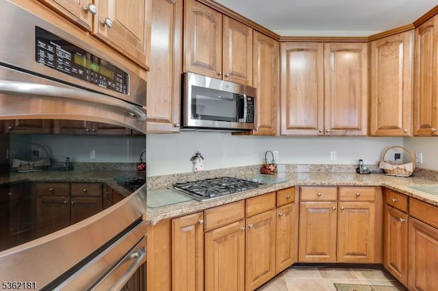 24 Quartz Way, Woodland Park, NJ 07424 - kitchen featuring appliances with stainless steel finishes, brown cabinetry, and light stone countertops
