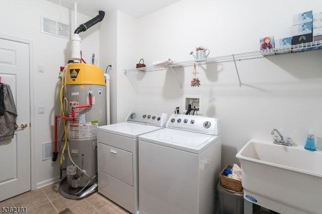 24 Quartz Way, Woodland Park, NJ 07424 - laundry area with water heater, washer and dryer, and light tile patterned flooring