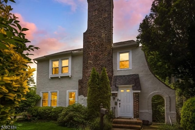 5 Canterbury Dr, Montclair Twp, NJ 07042 - view of front of house featuring stucco siding and a chimney