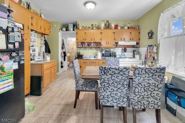 280 Highland Ave Unit 3, Kearny Town, NJ 07032 - kitchen with stainless steel microwave, freestanding refrigerator, under cabinet range hood, open shelves, and light countertops