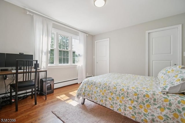 11 Western Blvd, Long Hill Twp, NJ 07933 - bedroom with a baseboard heating unit, wood finished floors, and an office area