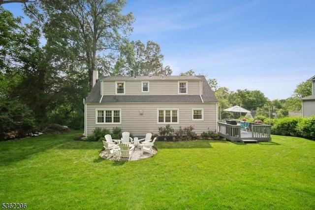 11 Western Blvd, Long Hill Twp, NJ 07933 - back of house with a wooden deck, a lawn, and a chimney