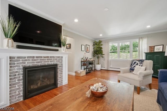 11 Western Blvd, Long Hill Twp, NJ 07933 - living room with crown molding, a brick fireplace, wood finished floors, a baseboard heating unit, and recessed lighting