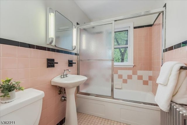 248 Knickerbocker Rd, Closter Boro, NJ 07624 - full bath with tile walls, radiator, toilet, shower / bath combination with glass door, and tile patterned floors