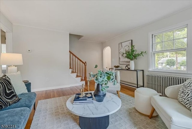 248 Knickerbocker Rd, Closter Boro, NJ 07624 - living room featuring radiator, wood finished floors, stairway, arched walkways, and crown molding