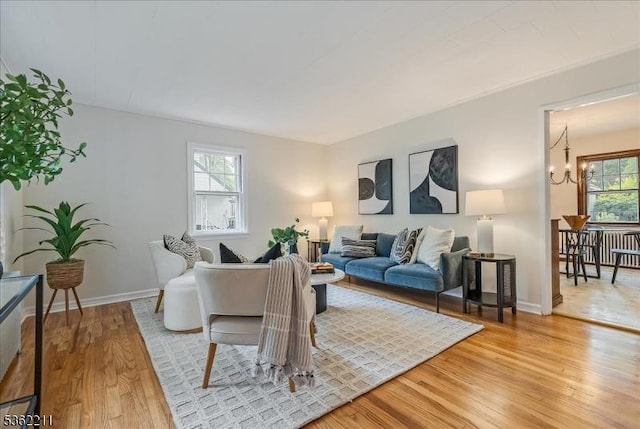 248 Knickerbocker Rd, Closter Boro, NJ 07624 - living room with a chandelier, healthy amount of natural light, light wood-type flooring, and baseboards