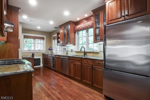 89 Maple St, Millburn Twp, NJ 07041 - kitchen with stainless steel appliances, a sink, light stone counters, exhaust hood, and recessed lighting