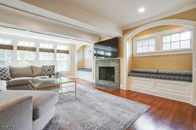 89 Maple St, Millburn Twp, NJ 07041 - living room featuring crown molding, arched walkways, healthy amount of natural light, wood finished floors, and a fireplace with flush hearth
