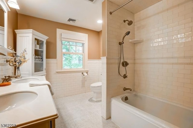 89 Maple St, Millburn Twp, NJ 07041 - full bathroom featuring tile patterned floors, toilet, tile walls, double vanity, and tub / shower combination
