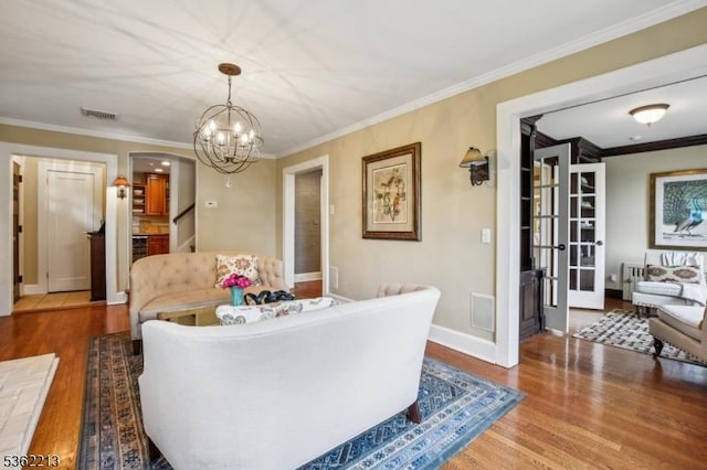 89 Maple St, Millburn Twp, NJ 07041 - living room with wood finished floors, a chandelier, crown molding, and baseboards
