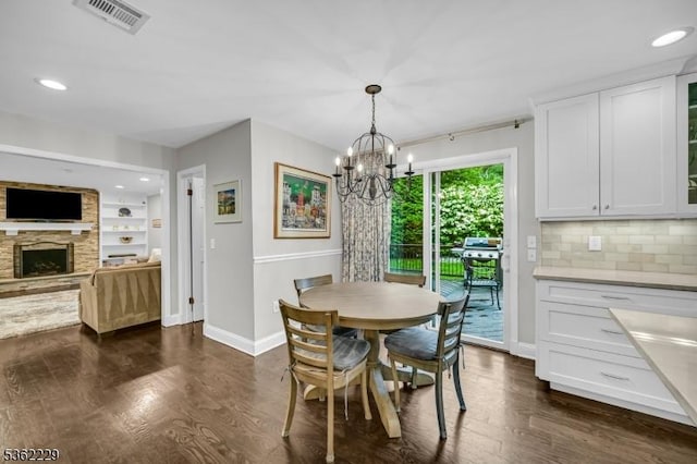 48 Kahdena Rd, Morris Twp, NJ 07960 - dining area featuring a chandelier, baseboards, a stone fireplace, dark wood-style floors, and recessed lighting