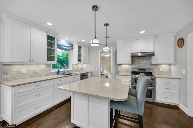 48 Kahdena Rd, Morris Twp, NJ 07960 - kitchen with range with two ovens, a sink, under cabinet range hood, dishwashing machine, and white cabinets