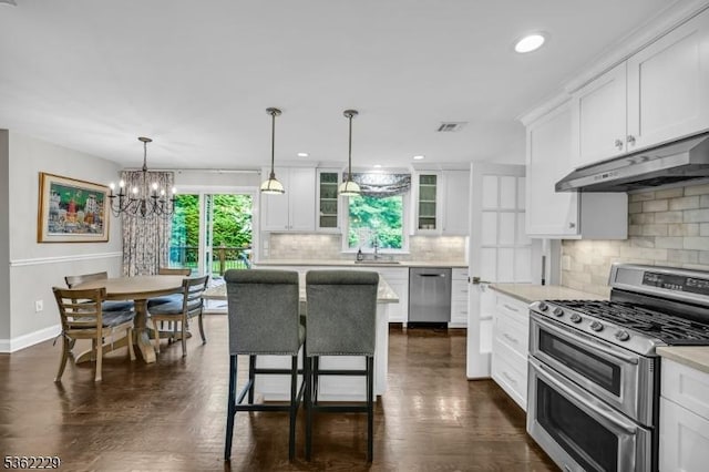 48 Kahdena Rd, Morris Twp, NJ 07960 - kitchen with stainless steel appliances, under cabinet range hood, white cabinets, light countertops, and decorative backsplash
