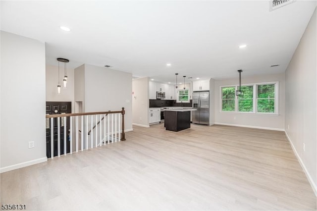 10 Maple Dr, Vernon Twp, NJ 07461 - unfurnished living room with light wood-style floors, baseboards, and recessed lighting