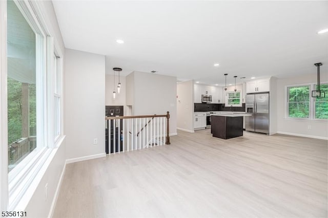 10 Maple Dr, Vernon Twp, NJ 07461 - kitchen with stainless steel appliances, baseboards, a kitchen island, light wood-style floors, and recessed lighting