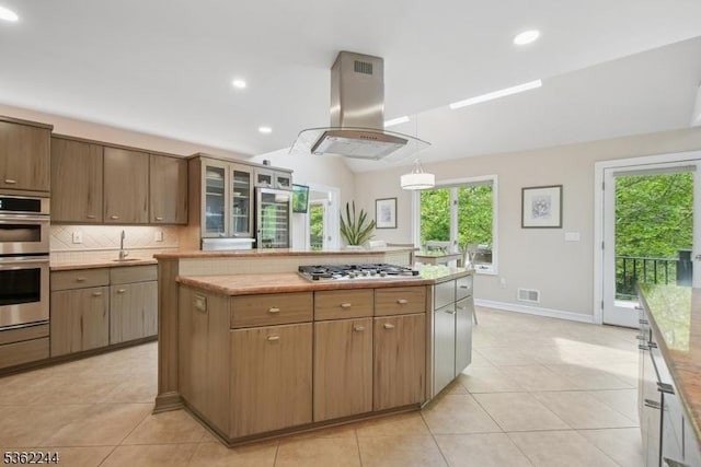 25 Hook Mountain Dr, Clinton Twp, NJ 08801 - kitchen featuring island range hood, stainless steel appliances, decorative backsplash, a center island, and light tile patterned floors