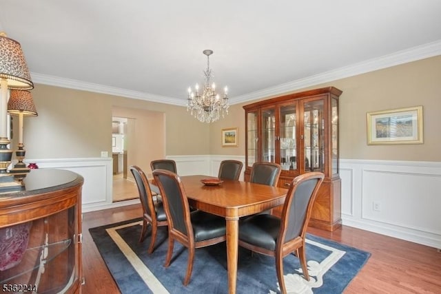 25 Hook Mountain Dr, Clinton Twp, NJ 08801 - dining space with crown molding, dark wood-type flooring, a wainscoted wall, a chandelier, and a decorative wall