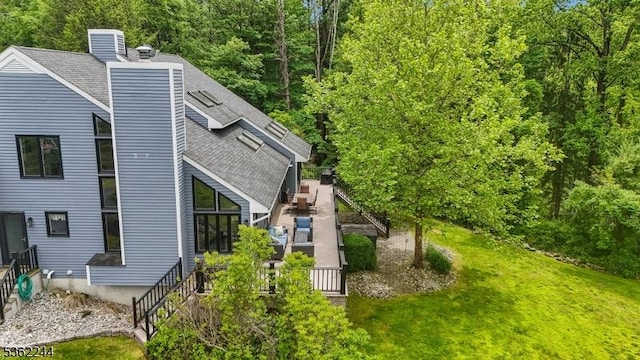 25 Hook Mountain Dr, Clinton Twp, NJ 08801 - view of side of home featuring a chimney, a shingled roof, and a lawn