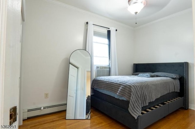 513 Maple Ave, Elizabeth City, NJ 07202 - bedroom featuring a baseboard heating unit, wood finished floors, and ornamental molding