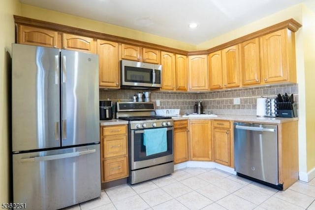 513 Maple Ave, Elizabeth City, NJ 07202 - kitchen with appliances with stainless steel finishes, light countertops, light tile patterned floors, tasteful backsplash, and recessed lighting