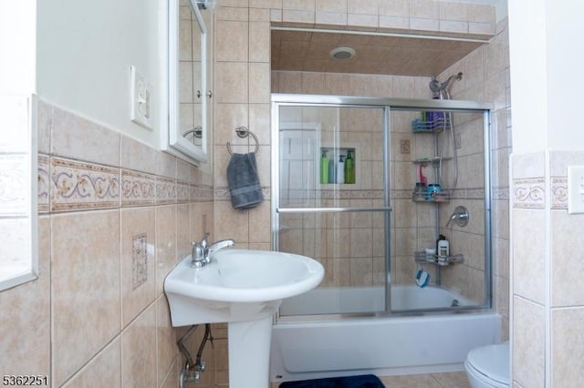 513 Maple Ave, Elizabeth City, NJ 07202 - full bath with tile walls, shower / bath combination with glass door, toilet, and tile patterned floors
