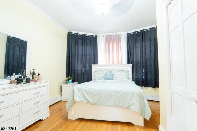 513 Maple Ave, Elizabeth City, NJ 07202 - bedroom with light wood-style floors, ornamental molding, and baseboards