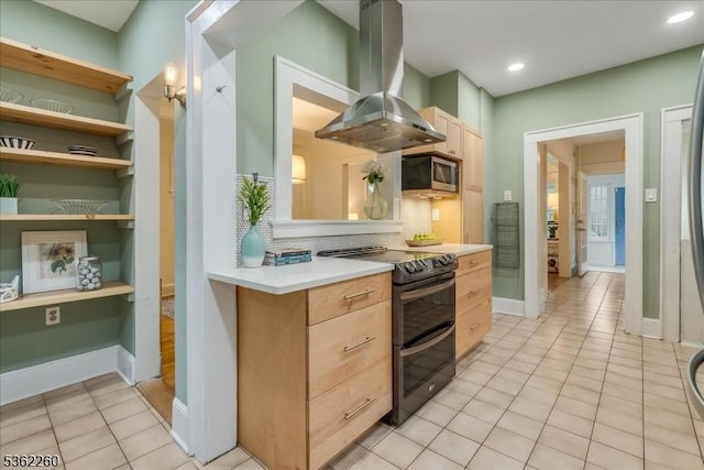 179 W Fairview Ave, South Orange Village Twp, NJ 07079 - kitchen with island exhaust hood, range with two ovens, stainless steel microwave, light brown cabinets, and tasteful backsplash