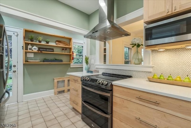 179 W Fairview Ave, South Orange Village Twp, NJ 07079 - kitchen featuring stainless steel appliances, island exhaust hood, light brown cabinetry, light tile patterned floors, and tasteful backsplash