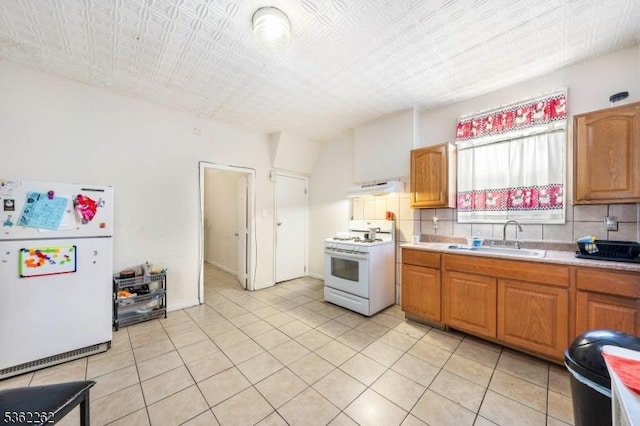639 N 8th St, Newark City, NJ 07107 - kitchen featuring white appliances, a sink, under cabinet range hood, light countertops, and decorative backsplash