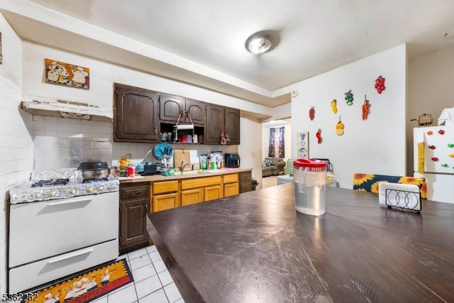 639 N 8th St, Newark City, NJ 07107 - kitchen featuring white appliances, backsplash, a sink, dark brown cabinetry, and light tile patterned floors