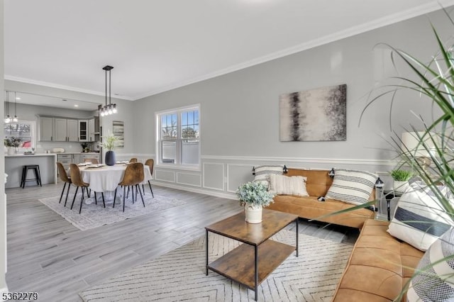 28 Kenmore Rd, Edison Twp, NJ 08817 - living area with ornamental molding, light wood-style flooring, wainscoting, and a chandelier