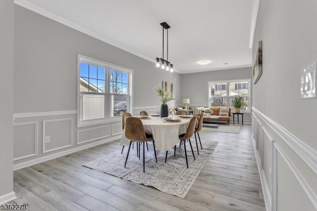 28 Kenmore Rd, Edison Twp, NJ 08817 - dining room with crown molding, a decorative wall, wainscoting, and light wood-style flooring