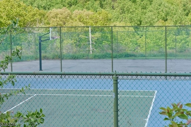 9B Foxwood Dr Unit B, Morris Plains Boro, NJ 07950 - view of tennis court featuring community basketball court and a forest view