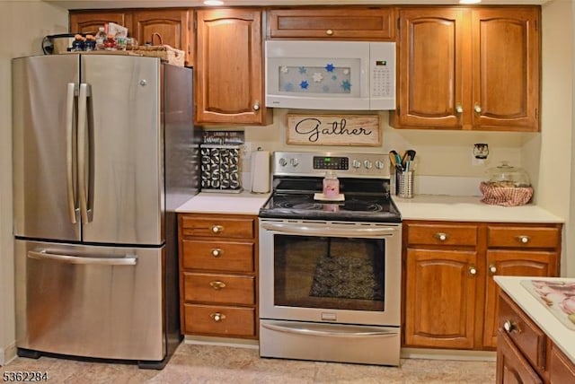 9B Foxwood Dr Unit B, Morris Plains Boro, NJ 07950 - kitchen with appliances with stainless steel finishes, light countertops, and brown cabinetry