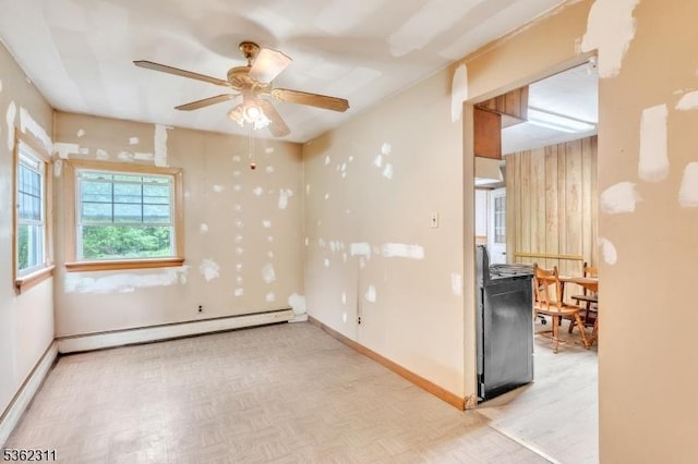 237 Whitmore Ave, Wayne Twp, NJ 07470 - empty room with baseboard heating, ceiling fan, baseboards, and parquet floors