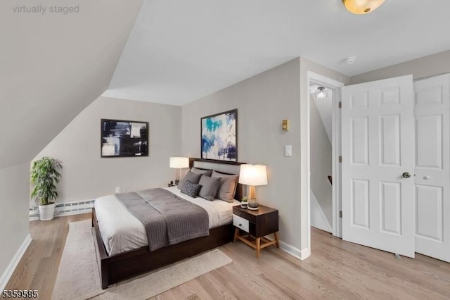 10 Rutgers Way, Hopatcong Boro, NJ 07843 - bedroom featuring a baseboard heating unit, wood finished floors, baseboards, and lofted ceiling