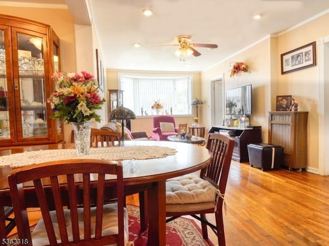 148 Hackensack St, Wood-Ridge Boro, NJ 07075 - dining space featuring ceiling fan, light wood finished floors, and crown molding