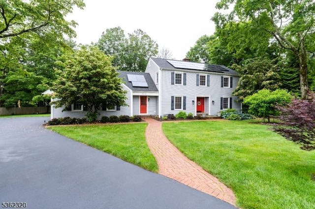 41 Wilkinson Rd, Randolph Twp, NJ 07869 - colonial house featuring roof mounted solar panels and a chimney