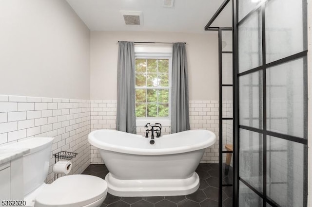 41 Wilkinson Rd, Randolph Twp, NJ 07869 - full bathroom featuring tile walls, a soaking tub, wainscoting, tile patterned flooring, and vanity