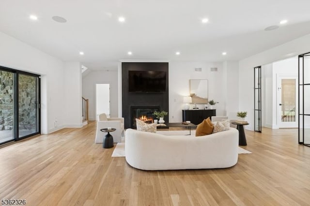 121 Culberson Rd, Bernards Twp, NJ 07920 - living room with light wood finished floors, a large fireplace, recessed lighting, and baseboards